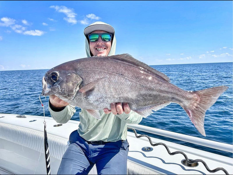 Angler holding a barrelfish on a boat off Alabama
