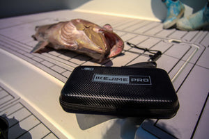 IKEJIME PRO kit case on a boat deck with a freshly caught grouper behind it
