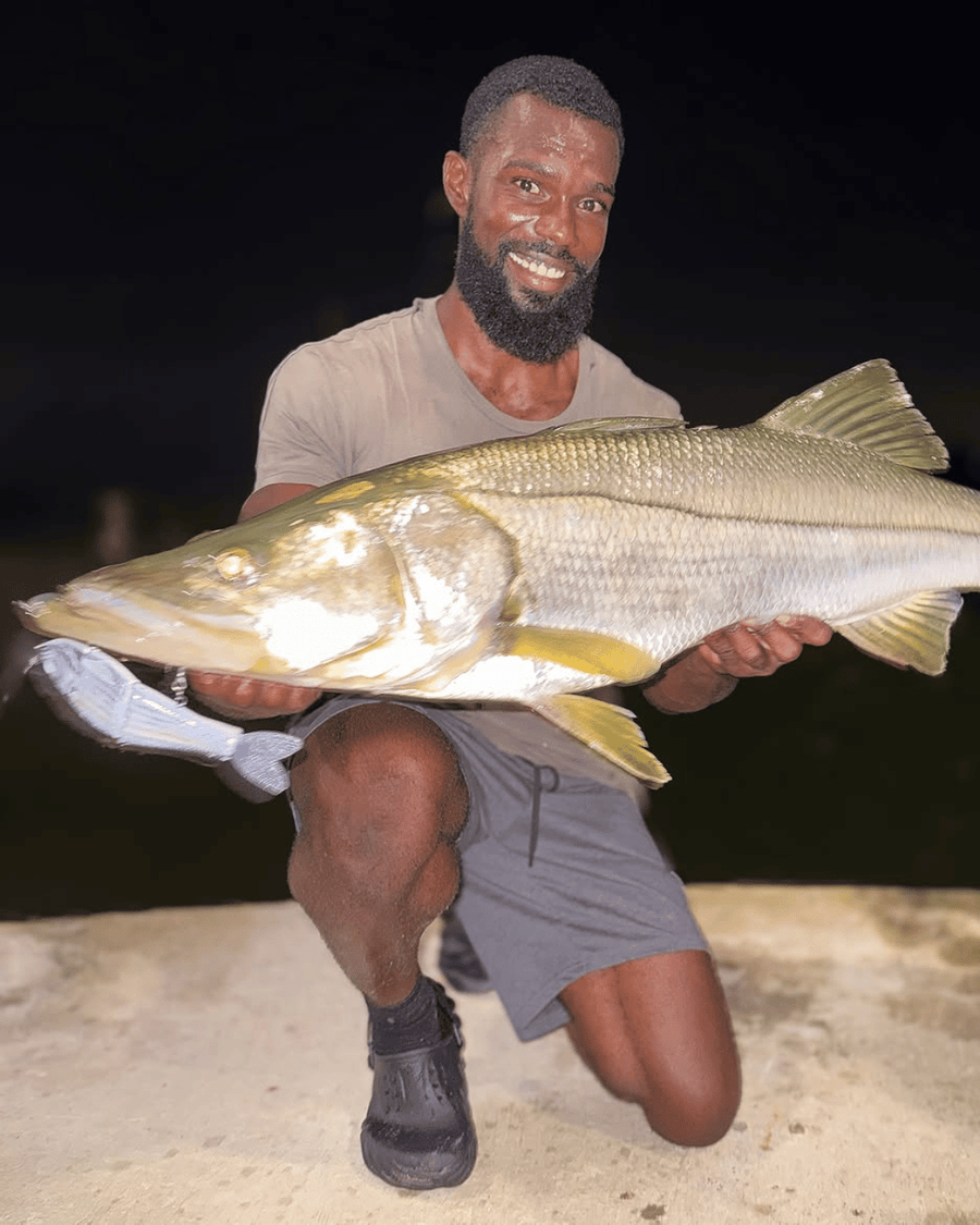 Angler holding a 42 inch snook caught on a GLYDE glide bait